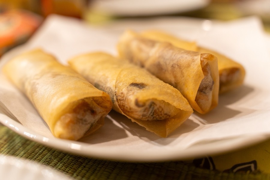 Golden fried egg rolls on a plate